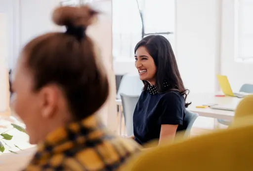 femme qui rit pendant une réunion d'entreprise